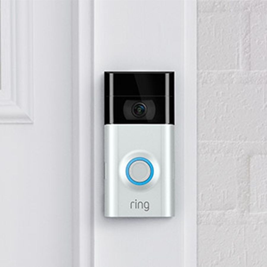 A Ring video doorbell next to a front door