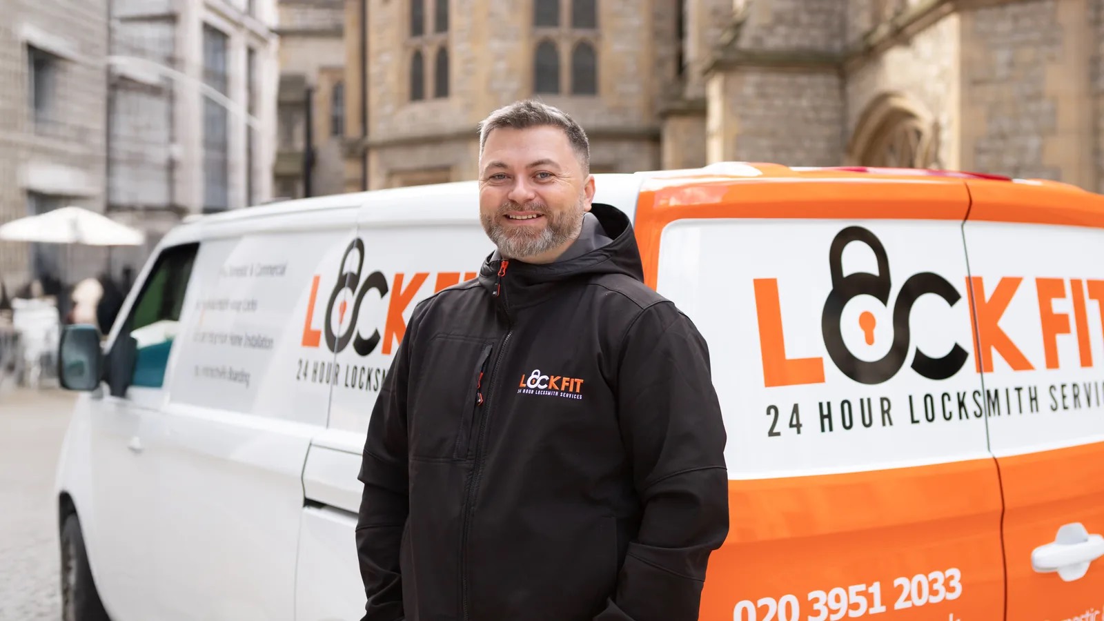 A LockFit locksmith standing in front of his LockFit van